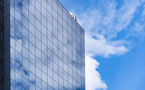 crisvisa-control-solar-EVO-STB-120-modern-glass-building-architecture-with-blue-sky-and-clouds